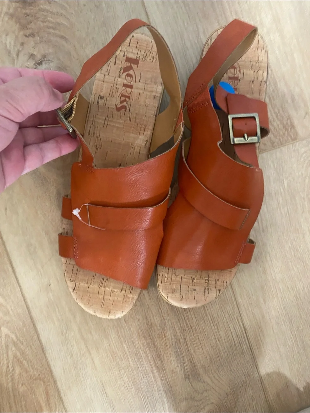 Women’s Korks platform wedge sandals feature a cork sole slingback buckle.